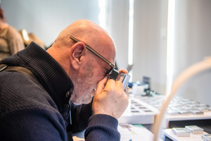 man looking at diamond close up